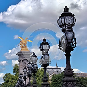 Golden statues and lamps on the Alexander III bridge in Paris