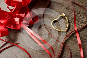Golden steel heart with some red ribbons
