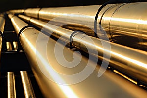 Golden steel pipeline during sunset