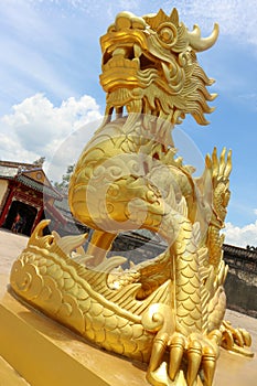 Golden stone dragon statue in Hue Palace, Vietnam