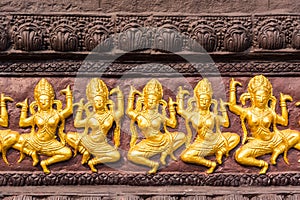 Golden stucco of the angle at the wall of Thai temple