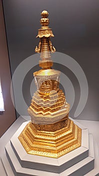 Golden Buddhist stupa decoration exhibit in musiem