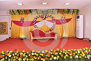 Golden style Indian stage decoration with multi color flowers, props and lights