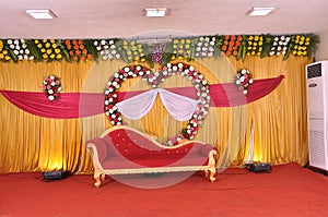 Golden style Indian stage decoration with multi color flowers, props and lights