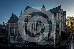 The golden sun sets behind the St.Nikolas church in Ghent, Belgium