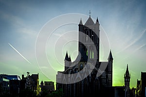 The golden sun sets behinf the St.Nikolas church in Ghent, Belgium