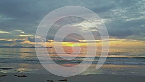 Golden Sunrise above Ocean Girl Passes Camera on Beach