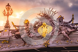 Golden sunrise and nymphs in Pont Alexandre III, Paris, france