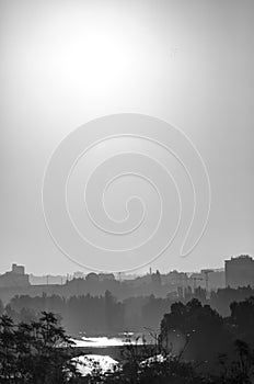 Golden sunrise in Prague taken from the Letna park, with cityscape and the Vltava river in black and white