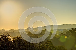 Golden sunrise in Prague taken from the Letna park, with cityscape and the Vltava river on the horizon