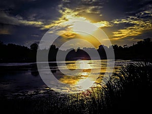 Golden Sunset Clouds Reflection Over Golden Pond