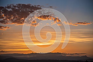 Golden sunset on different layers of clouds