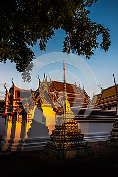 Golden Sunset light on the walls of Wat Pho Palace Bangkok Thailand Wat Phra Chetuphon Vimolmangklararm Rajwaramahaviharn