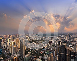 Sunset lightbeam with Bangkok city of cityscape skyline with skyscraper building background in Central business district photo