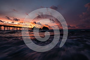 Golden sunset over the beach with a boardwalk