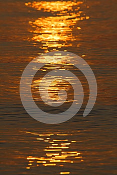 Golden sunset over a reflecting sea.