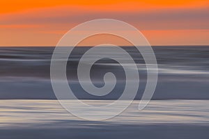 Golden sunset over the sea, abstract seascape background, motion blur