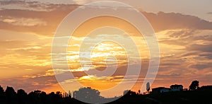 Golden sunset over tuscan winery in Italy. Toscana vinery view at evening, golden sun sunset. Dark vinery silhouette