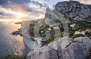 Golden sunset from Panea cliff with mountain cat koshka in background. Simeiz, Crimea. Black Sea