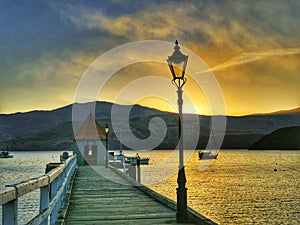 Golden sunset at a pier in Akaroa harbour at Canterbury region of New Zealand