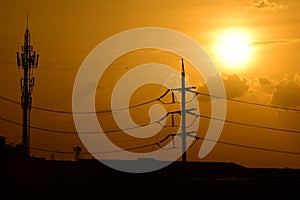 Golden sunset with Power poles and power lines.