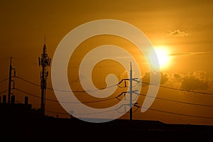 Golden sunset with Power poles and power lines.