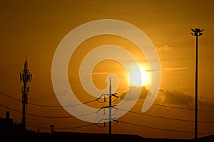 Golden sunset with Power poles and power lines.