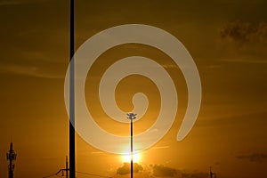 Golden sunset with Power poles and power lines.