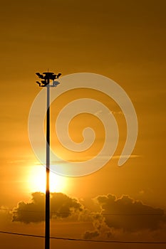 Golden sunset with Power poles and power lines.