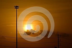 Golden sunset with Power poles and power lines.