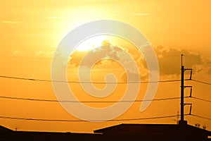 Golden sunset with Power poles and power lines.