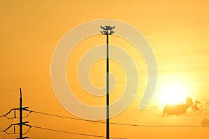 Golden sunset with Power poles and power lines.