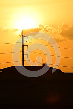 Golden sunset with Power poles and power lines.