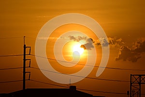 Golden sunset with Power poles and power lines.