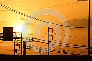 Golden sunset with Power poles and power lines.