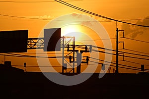 Golden sunset with Power poles and power lines.