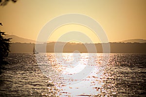 Golden sunset with sailboat on Lake Lanier photo