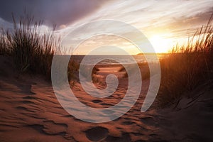 Golden sunset on the sea shore and footprints in the sand. Beautiful sand dunes.