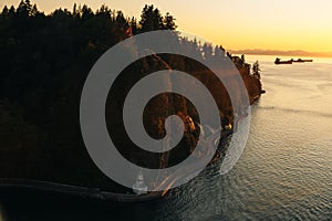 Golden Sunset into the sea with the silhouette of ship