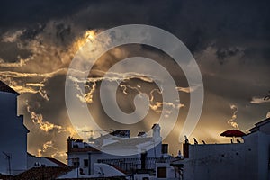 Golden sunset, sunbeams break through cloud. Sedella, Spain.