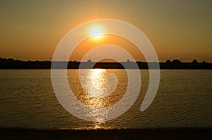 Golden sunset, water reflection, horizon, sun halo