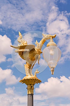 golden swan light bulb with blue sky background