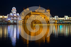 The Golden Temple at Amritsar, Punjab, India, the most sacred icon and worship place of Sikh religion. Illuminated in the night, r