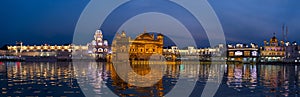 The Golden Temple at Amritsar, Punjab, India, the most sacred icon and worship place of Sikh religion. Illuminated in the night, r photo