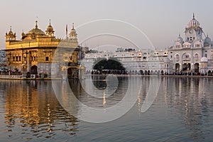 The Golden Temple at Amritsar, Punjab, India, the most sacred icon and worship place of Sikh religion. Sunset light reflected on l