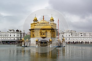 Golden Temple known as Harmandir Sahib in Amritsar, Punjab, India in overcast weather with grey sky