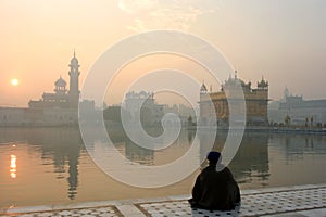 Golden temple with a man in meditation