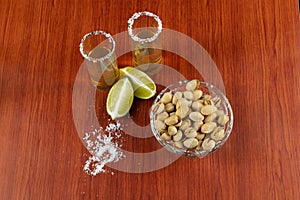 Golden tequila with lemon, pistachos, cacahuate, and salt. Drinks, Liquor