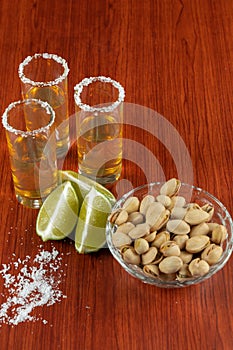 Golden tequila with lemon, pistachos, cacahuate, and salt. Drinks, Liquor
