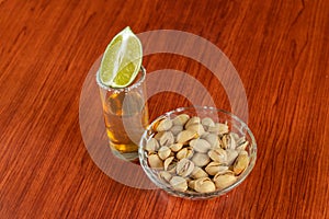 Golden tequila with lemon, pistachos, cacahuate, and salt. Drinks, Liquor